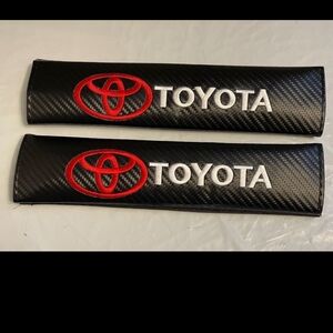 COPY - 2 new Toyota embroidered seat belt covers.